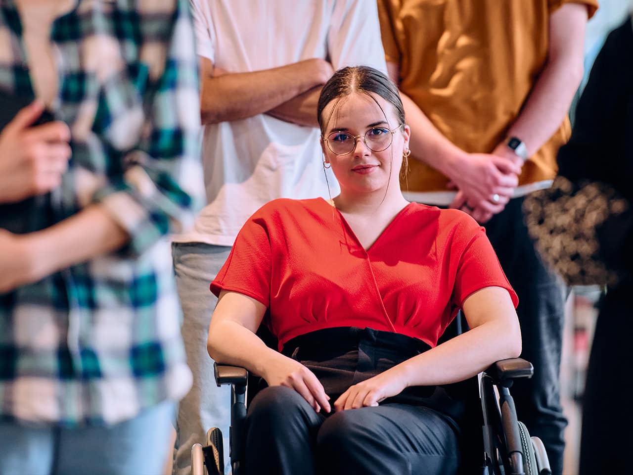 woman in wheelchair sitting in a crowd