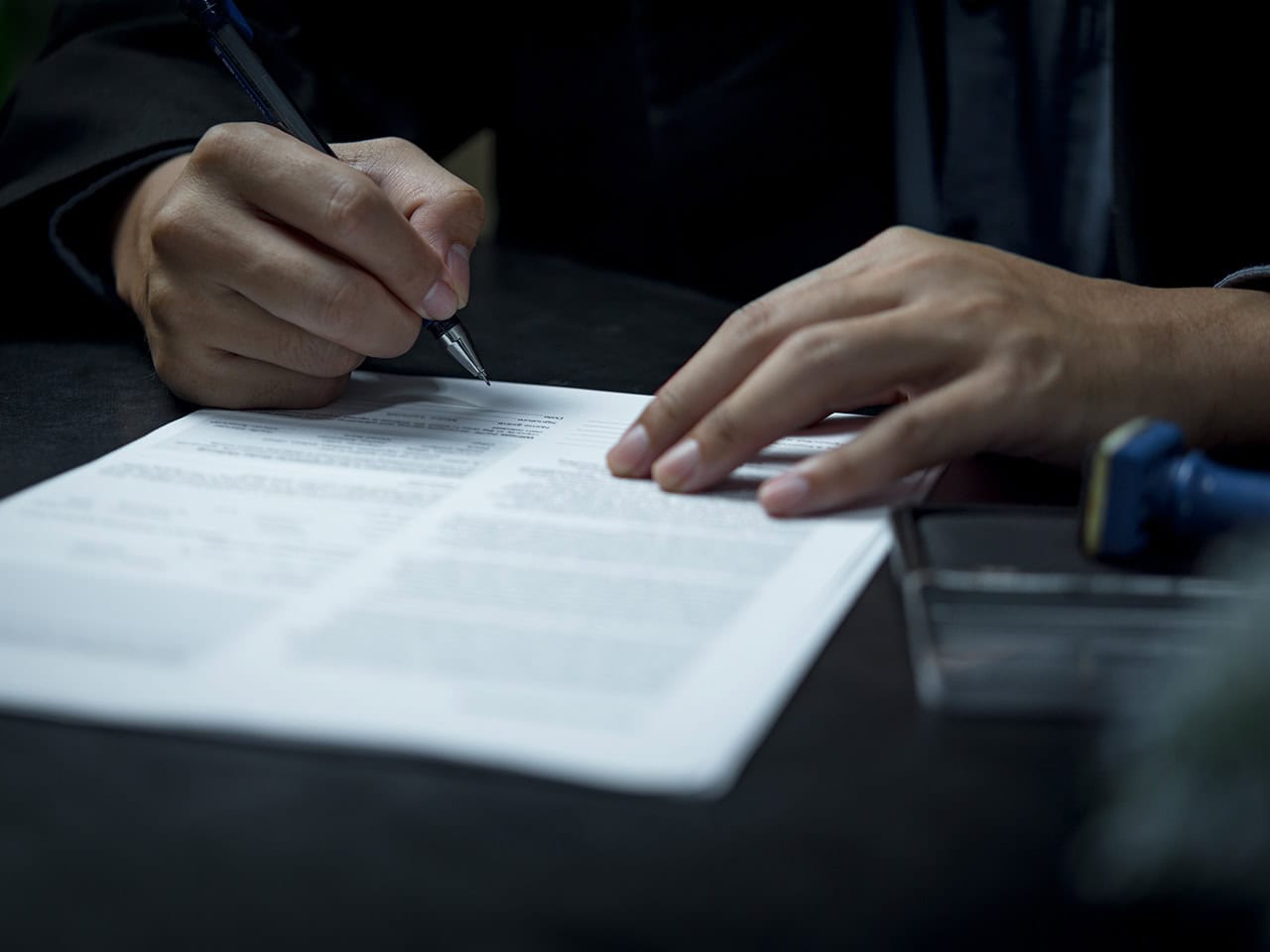 man signing document