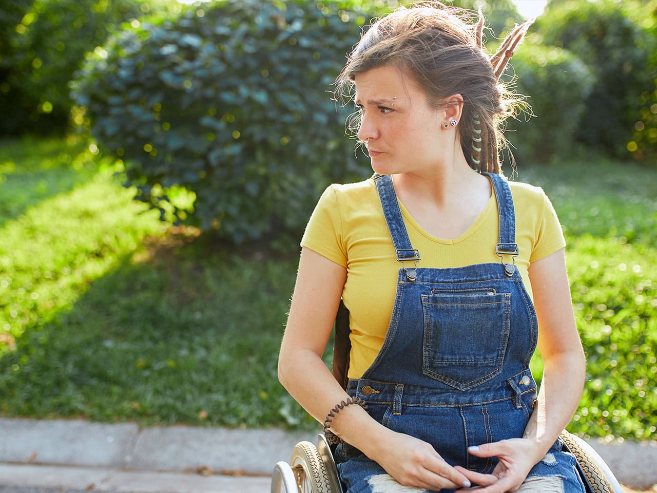 younger woman in wheelchair staring into the distance