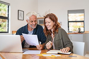 Picture of a middle aged couple talking at kitchen table