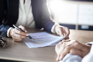 Picture of a lawyer reviewing documents with a client