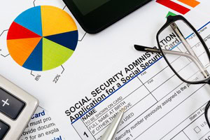 Social Security forms with glasses and calculator