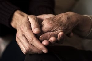 People clasping hands together