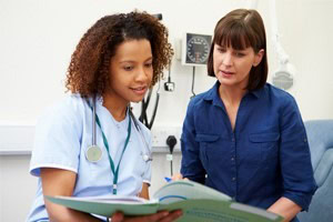 Photo of a doctor reviewing medical information with a patient