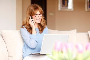 Picture-of-a-woman-sitting-on-couch-talking-on-the-phone