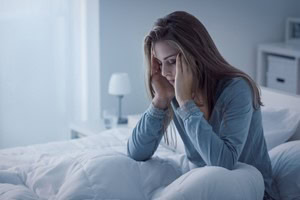 young woman sick in bed