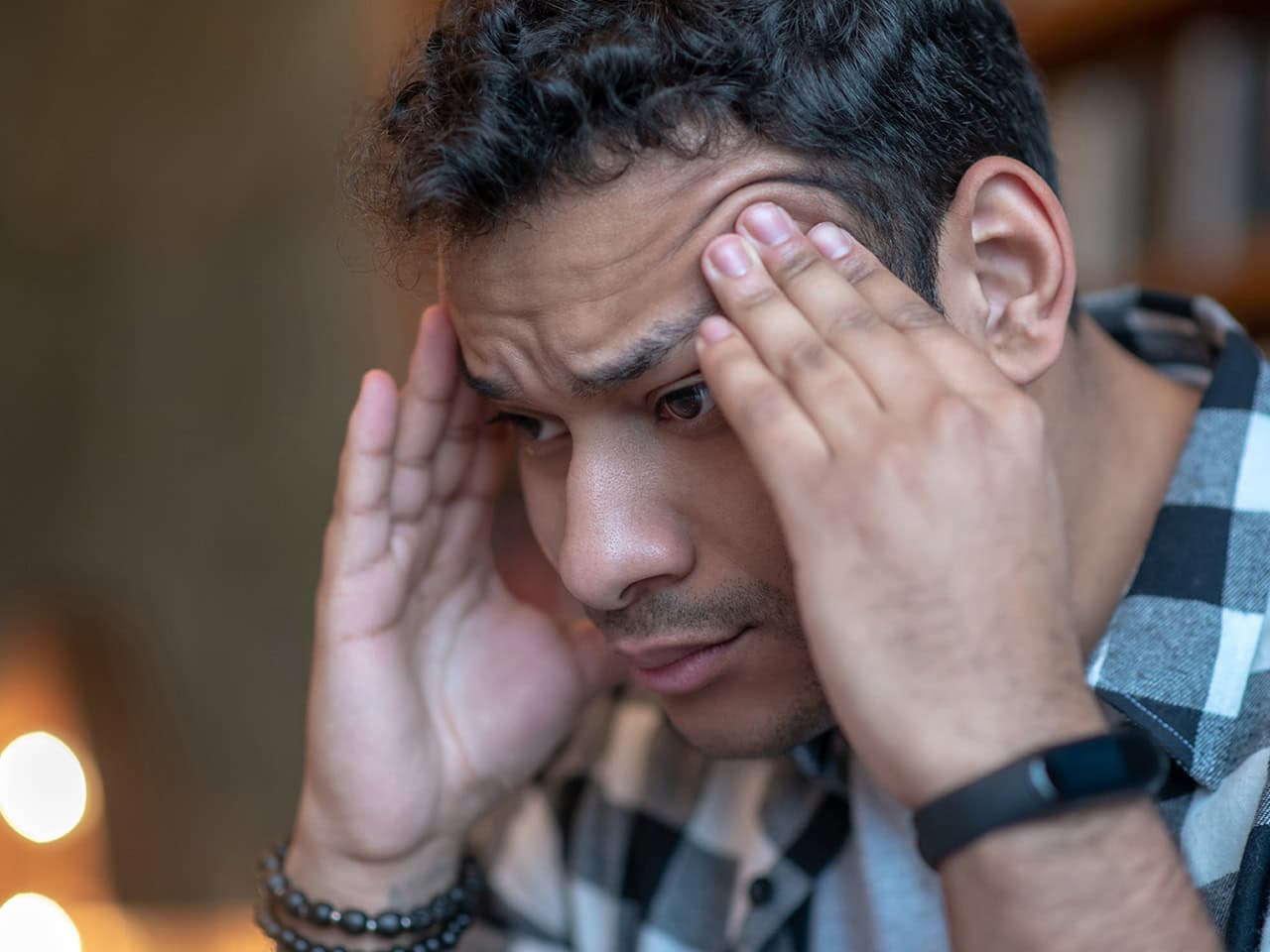 stressed man with his hands on his head