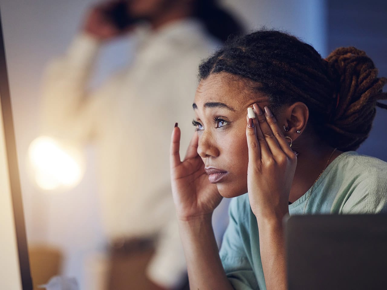 stressed woman holding her head