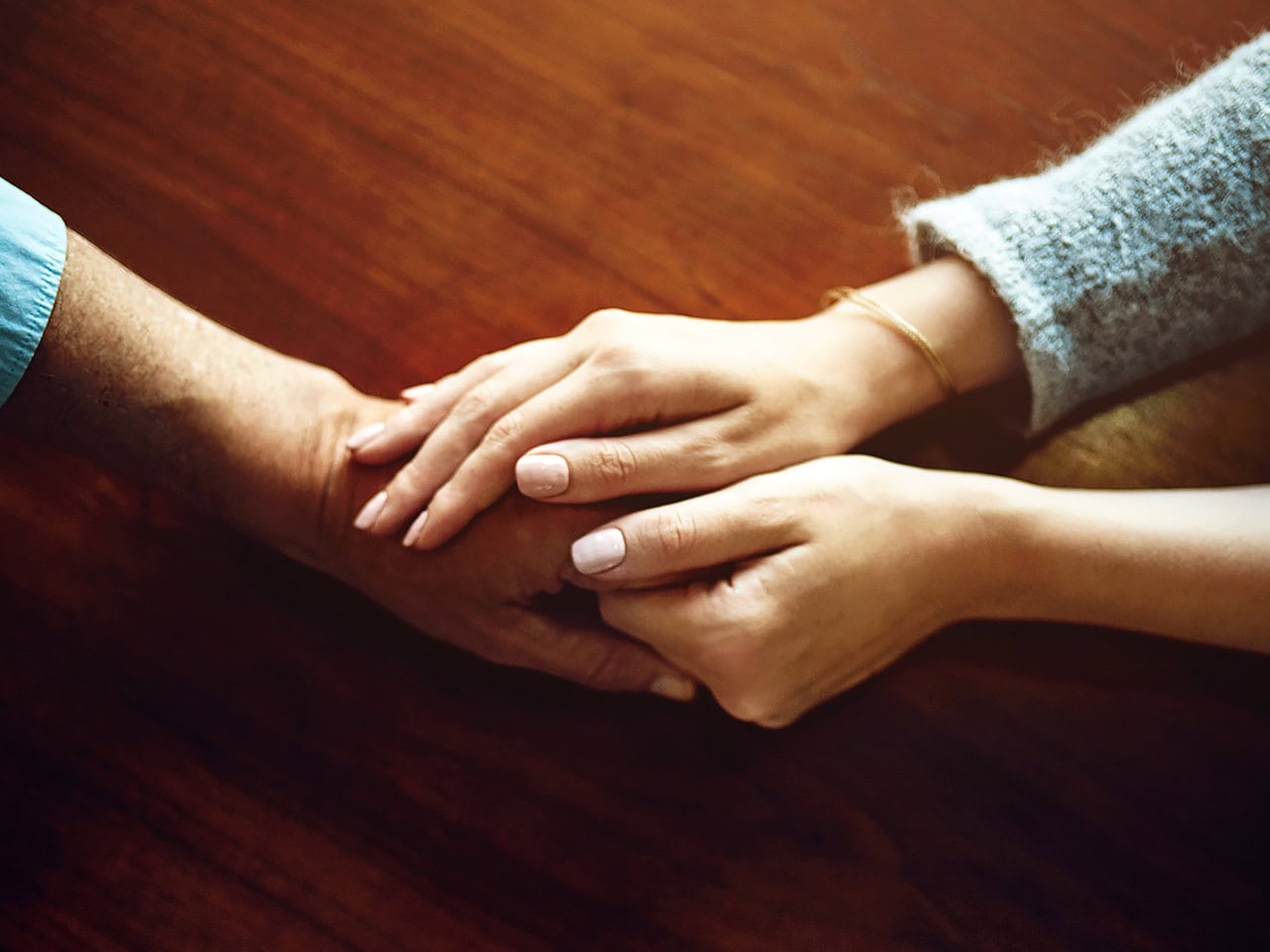 Comforting hands on table