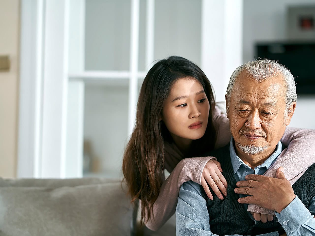 Elderly father and concerned daughter sitting