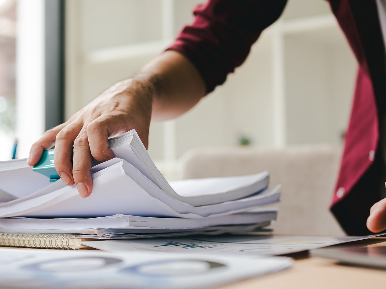 Woman going through a stack of documents