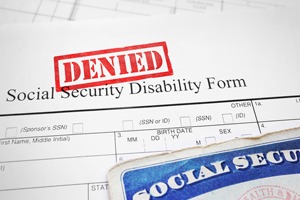 Social security disability form with red "denied" stamp with a red "denied" stamp across it