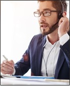 Man wearing a headset, on the phone with a client