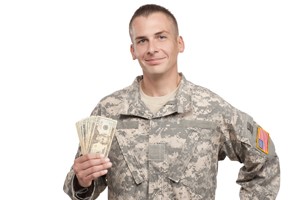 Military veteran holding cash
