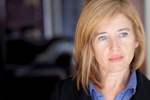 Picture of a middle aged blonde woman with blue eyes looking upset