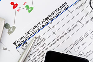 Social security forms, pen and a cell phone