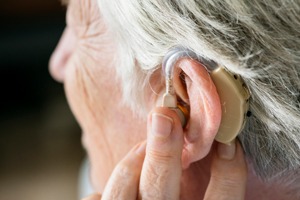 elderly woman using a hearing aid