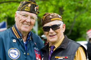 Veterans standing next to each other at event, smiling for a photo