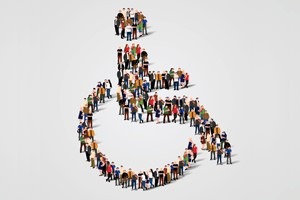 people lined up forming disability symbol